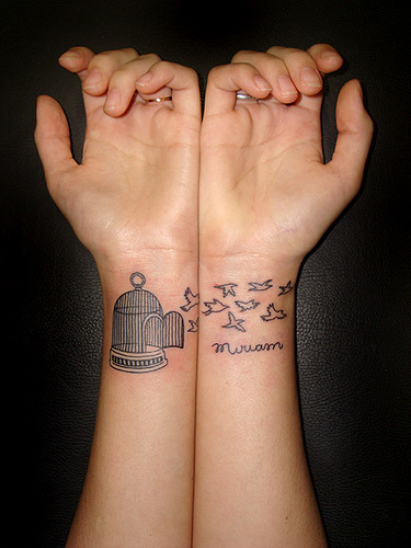 Birdcage tattoo on wrist